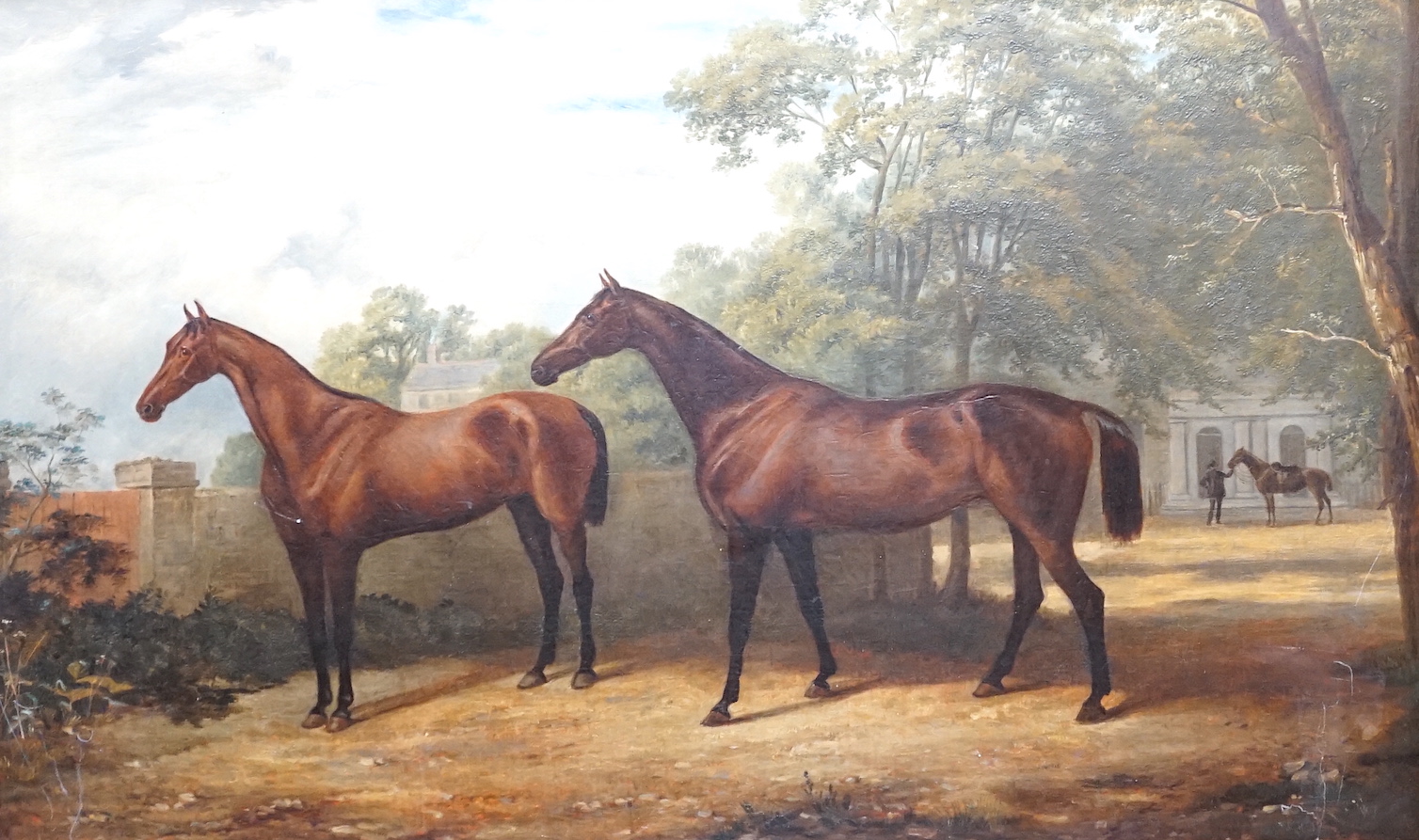 English School c.1900, oil on canvas, Portrait of two racehorses standing in parkland, a groom and another horse beyond, 48 x 76cm